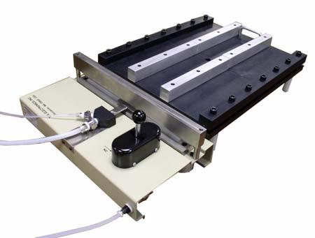 Restraining plate fixtures for seal strength tests provide consistent stress loading on all seals.