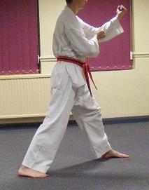 Step the left foot out to form a walking stance whilst