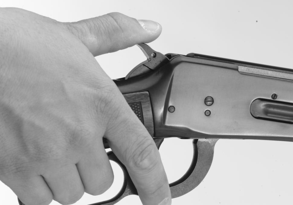 Get a stable grip on your shotgun with your hand in shooting position. Place your thumb on the hammer and firmly hold the hammer back slightly with your thumb. 3.