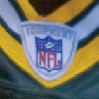 exhibited below the NFL Equipment shield patch that is stitched on the collar.