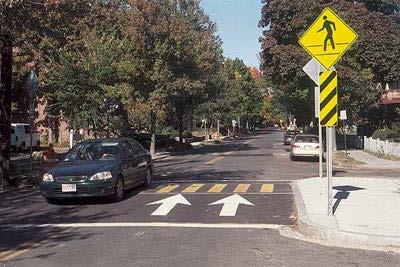 Raised Crosswalks Raise crosswalk to height of sidewalk and narrow road with curb extensions at