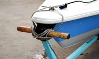 Leave the stern dolly (the wood piece with two wheels) and its pin in the slot the