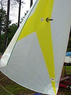 Step 13: With the spinnaker partially flying (held out) to the port side (left), locate the retrieval point (black arrow).