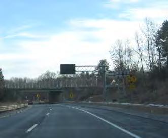 A variable message sign (STOPPED TRAFFIC AHEAD) is located on Route 2 eastbound, approximately 1,500 feet west of the intersection and in advance of a horizontal curve.