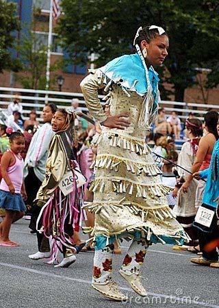 Women s Jingle Dress Traditional Ojibwa dance Cloth dress decorated with hundreds of metal cones Contemporary dancers carry eagle wing fans raised during honour beats
