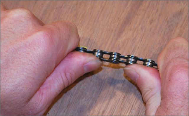 Figure 8 - Relaxing a stiff link To fix a stiff link, hold the chain so you can work the links side to side as shown in Figure 8.
