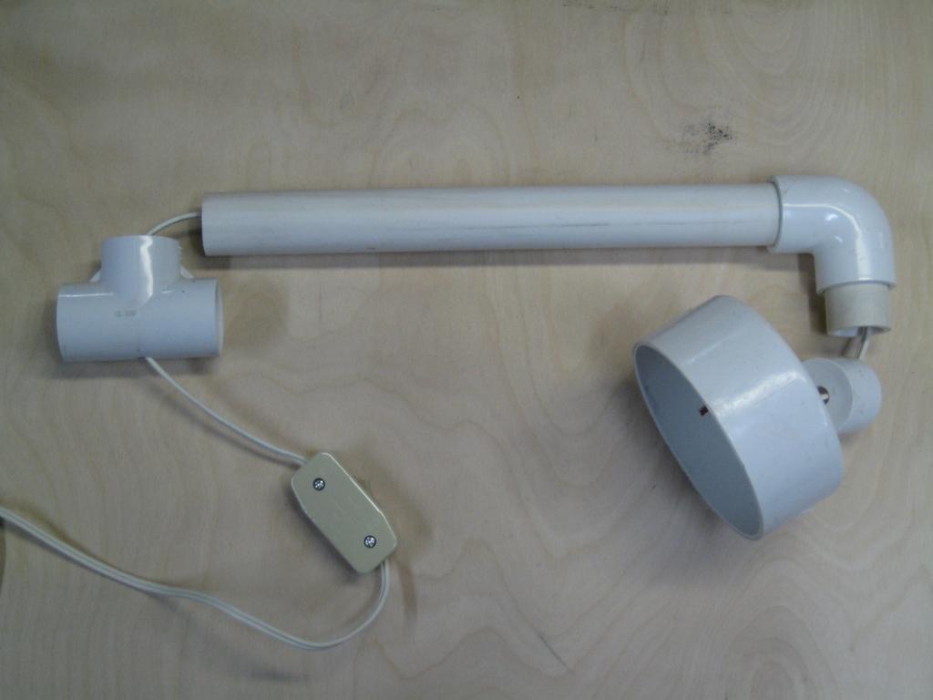 4. Cut a 6 ¾-inch length of 4-inch pipe for the lampshade. (See Photo 2.) 5. Drill a 3/8-inch hole in the center of each cap. (See Photo 6.) 6. Assemble the lamp's neck as shown in Photo 5.