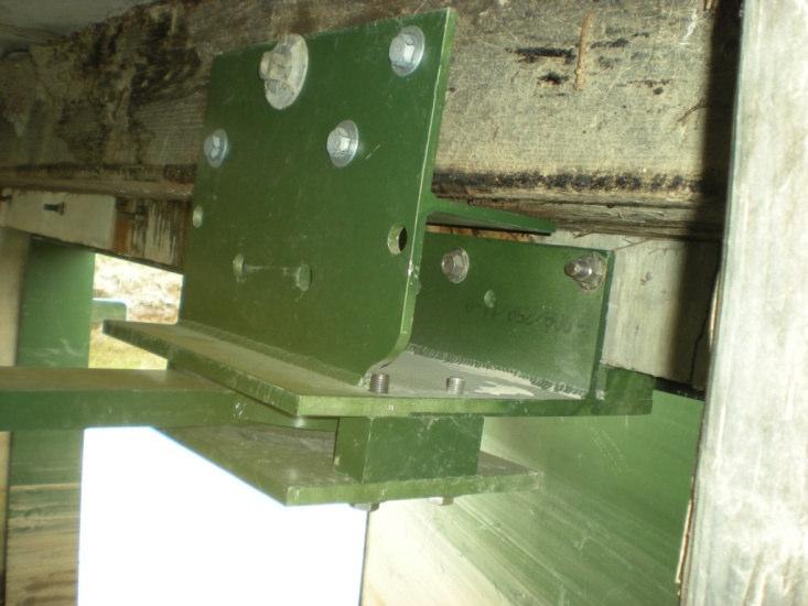 As the float falls, levers and linkage move the arms (one arm is shown/circled in the photo above) so as to push the gate open.