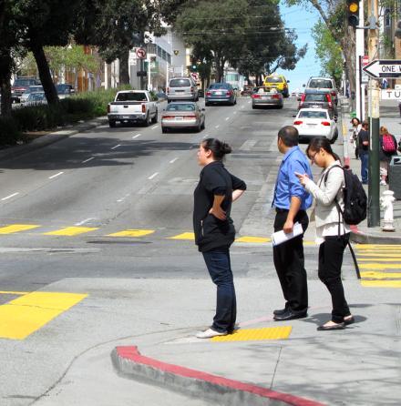 Curb bulbs, also known as corner bulbouts or curb extensions, extend the sidewalk into the intersection and reduce effective curb-to-curb crossing width.