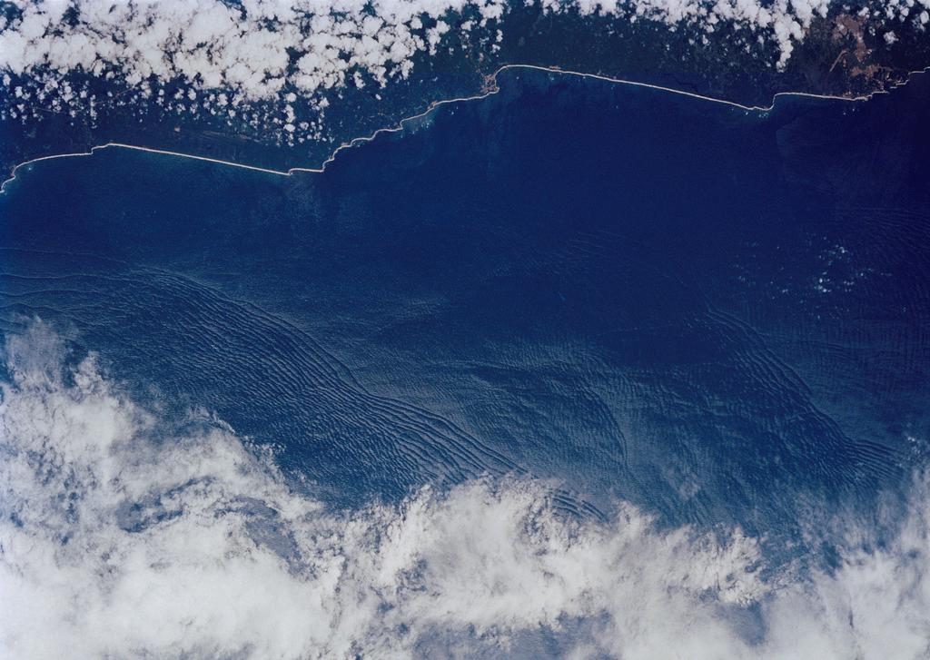 An Atlas of Oceanic Internal Solitary Waves (February 2004) Figure 7. Astronaut photograph (STS041-82-9) along the Ivory Coast acquired on 9 October 1990 at 1057 UTC.