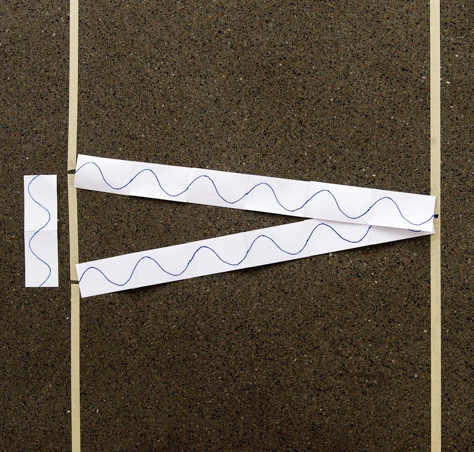 Tear off several long strips of masking tape. Tape them in a line on the floor, leaving two small slits that are approximately two "blue" wavelengths (25 cm) apart.