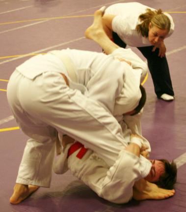 The other two mat officials also move freely about the mat so that they can get another view of the action to assist in making the correct call.