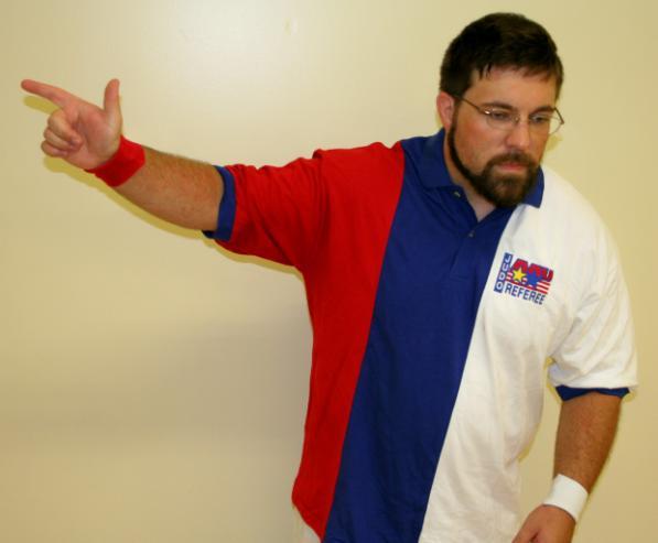 Freestyle judo referee Jake Pursley demonstrates the correct hand signals.