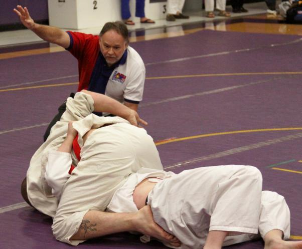 At this time, the pinner must attempt a choke or armlock on his opponent. In this photo, the pinner holds his opponent with Kami Shiho Gatame.