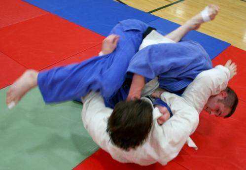 2-The attacker (on bottom) spins under his opponent and rolls him over onto his back. 3-The attacker has successfully rolled his opponent over onto his back and scores 1 point.
