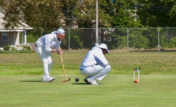 Jonathan Parisi takes a shot while Ralph Charles watches for contact Sunday saw the Championship take shape as seeded players started
