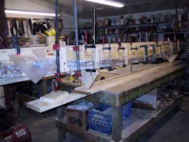 This example shows the construction of the new deck beams, each made of six layers of wood, epoxy glued and clamped in a