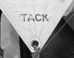 10. Using a bowline, tie the corner of the gennaker marked tack to the tack line exiting from the front of the gennaker pole.