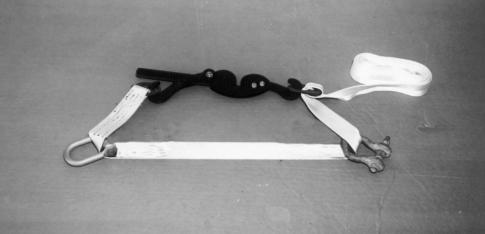3 Pass the free end of a tiedown strap through a clevis on a rail and up and over, around, or through the indicated tiedown provision on the load.