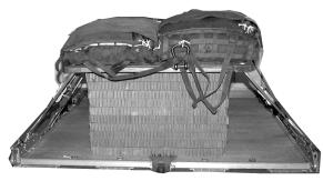 4 3 3 4 Set two parachutes side by side on the load with the riser compartments up and the bridles toward the rear of the platform.