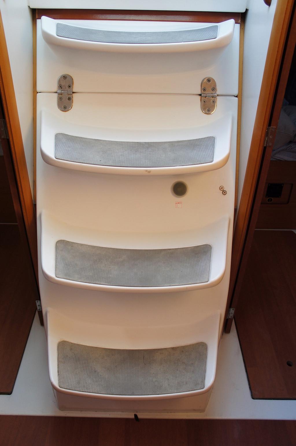 In the event of an engine fire, your companionway stairs is fitted with a small plastic hatch through which