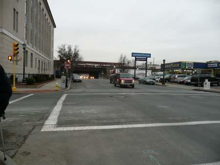 Bus stop at Dwight Street and Falcons Way is seen above. The parking garage reduces pedestrian appeal along this block.