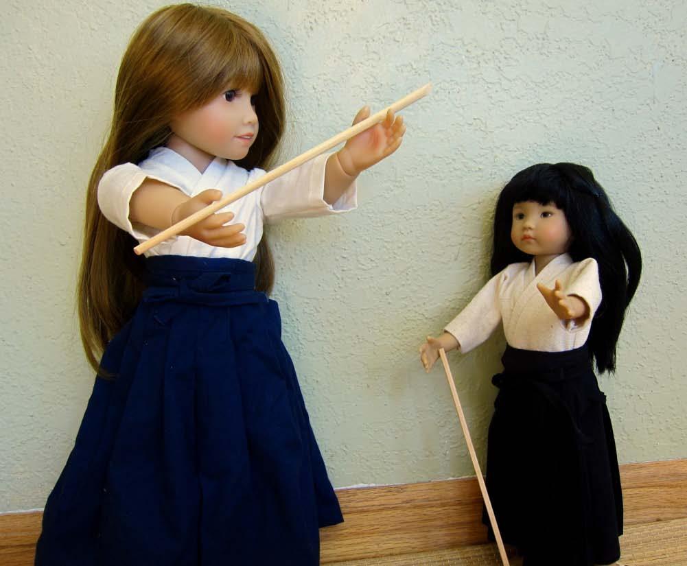 Galina demonstrates the use of a bokken ( 木剣 ) or wooden sword to Little Darling.
