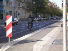 traffic (about 5,350 15,350 cars/24h) marked bicycle lane on road level before and after the