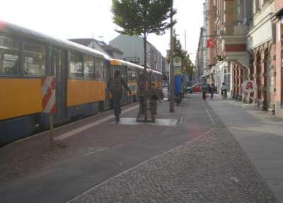 width) guidance of bicycle traffic at the tram stop: as a bicycle way over the cap, between waiting area and sidewalk behind the tram stop