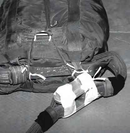 7 For a 22-foot cargo extraction parachute, run a length of type I, 1/4-inch cotton webbing through the top and bottom bag closing loops on the right side of the bag.