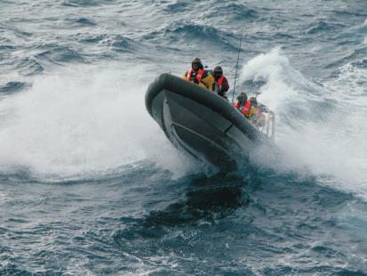 Australian Customs officers in a rigid inflatable vessel on a Southern Ocean operation.