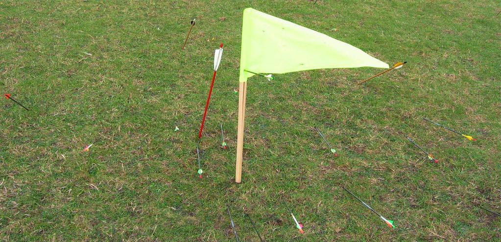 Longbows are often almost maxed-out, so they only have one choice, effectively 45 degrees, neither high nor low) the low trajectory will be best because the wind speed is nearly always significantly