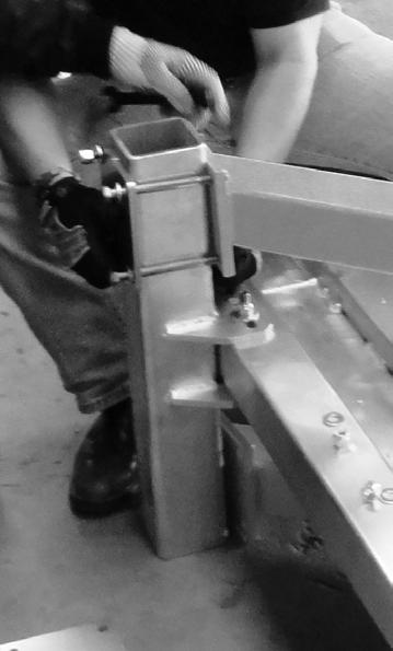 With a forklift (or other suitable equipment), guide the Rail Assembly in to place between the Upright Assemblies. Bolt in place with the head of the bolt inserted from inside of the Frame.
