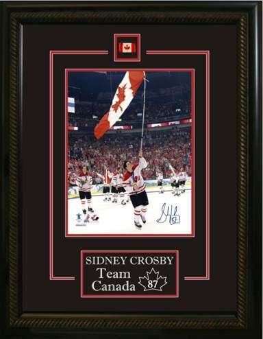 SIDNEY CROSBY SIGNED 8x20 ETCHED MAT TEAM CANADA 2010 CARRYING FLAG- This unique frame features a Sidney Crosby hand-signed 8" x 10" game photo with a laser etched description and a team pin.
