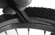 Locate the valve hole (usually opposite the maker s label) Place the valve through the hole and feed the inner tube into the tyre.