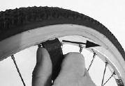 wheel rim.) Working away from the valve in both directions, feed the tyre back into the rim.