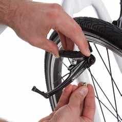 brake pads. Squeeze the brake arms together using your thumb and index finger and lift out the brake cable guide.