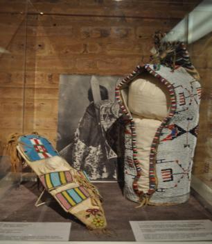 Why did they use such different materials to make these items? B. Look at the next two pictures below. They show a Plains headdress and cradleboard. 1.