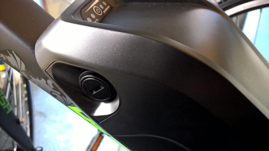 The battery lock is located on the opposite side to the charger socket (see photo above-right) and needs to be turned fully anti-clockwise to unlock the battery.