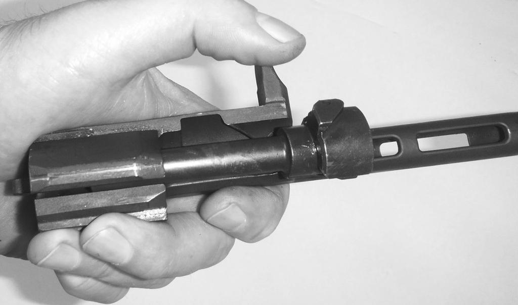 With the bolt at the bottom of the carrier, rotate the bolt clockwise until the bolt cam enters the bolt carrier cam