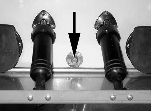 reverse gear. The bilge area drain plug is located at the front of the motor well, in the center under the engine.