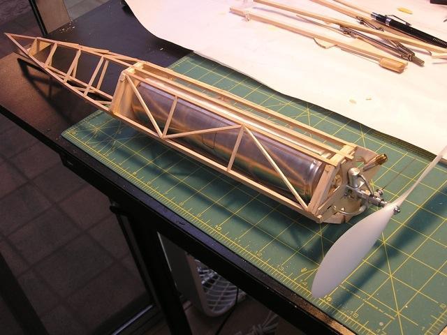 John Donelson has brought his model out to the Perris field and he s using a P-30 rolled tube fuselage and wing configuration with the air tank suspended below the fuselage.