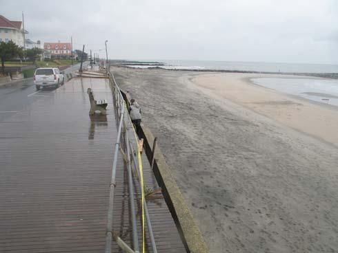 Age and decay has had an effect, but waves clearly broke over the top of the wall with sufficient force to dislodge about 50 feet of the boardwalk (right photograph in front of the white truck) and