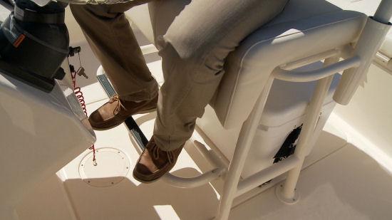 There s a molded footrest, a cross bar between the seat supports, and a flip-down footrest for