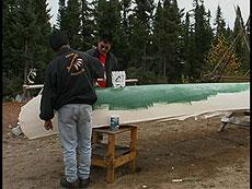 Alistair and Melvin painting the canoe.