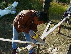3. The Gunwales Melvin cutting thin strips of wood for the minikukanashk u (gunwales).