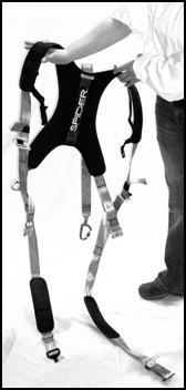 With all buckles unclipped, pick up harness by the shoulders to