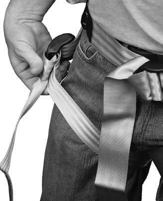 Hold the safety strap buckle in one hand and loop the free end completely around the