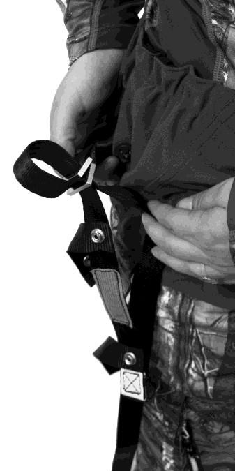 Adjust the Suspension Relief Strap by feeding the webbing through the Double Interlocking buckle (Figure B3b)
