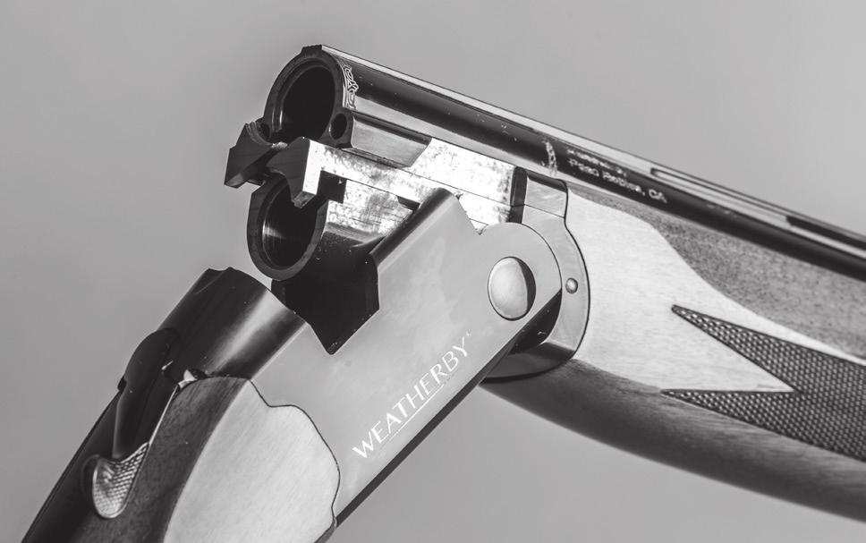 5. With one hand, grasp the receiver and buttstock assembly at the grip, then tuck the buttstock between your body and arm just above the waist while holding the barrel assembly with the other hand.